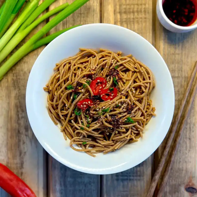Top view of a plate of cooked Organic Einkorn Spaghetti with assorted ingredients