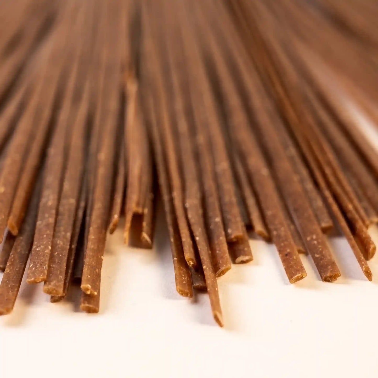Close-up of multiple pieces of uncooked Organic Einkorn Linguine